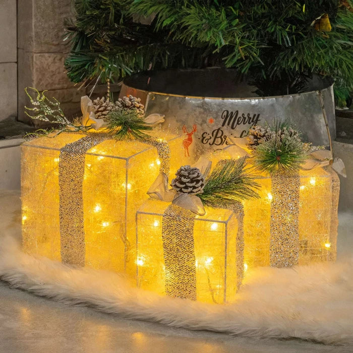 Verlichte kerstcadeaudozen - lichtgevende dozen met dennenappels en groen