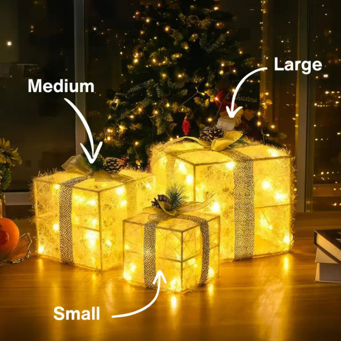 Verlichte kerstcadeaudozen - lichtgevende dozen met dennenappels en groen