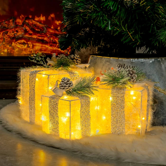 Verlichte kerstcadeaudozen - lichtgevende dozen met dennenappels en groen