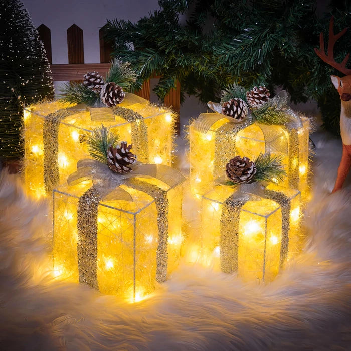 Verlichte kerstcadeaudozen - lichtgevende dozen met dennenappels en groen